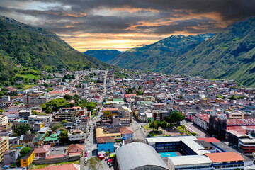 Fototapeta premium Aerial view over banos, a small city in the andes mountains in Ecuador during sunset