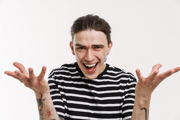 Naklejka premium Young white man with earring screaming and gesturing at camera