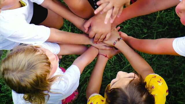 Children keep their hands together. Selective focus.