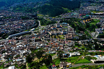 Aerial view of small suburbs and a large bus terminal in Quito, the capital city of Ecuador in South America