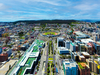 Aerial view over an empty football stadium inside a city © pangamedia