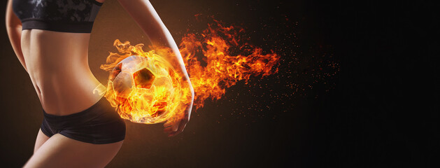 sexy girl is holding soccer ball with fire