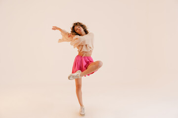 Young hispanic woman wearing skirt dancing on camera