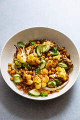 Roast cauliflower and chickpeas with pickled cucumber and red pepper sauce