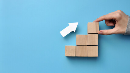Wooden cubes in the form of a growing graph. Growing profit chart
