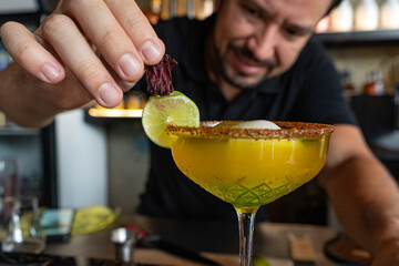 Barman decorates your cocktail.
