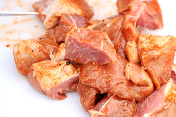 Meat kebab on the grill on a green background. Summer vacation and traditional outdoor BBQ picnic.