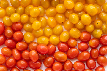 High angle view of full frame image of bright red and yellow tomatoes. Suitable for food background or artwork.