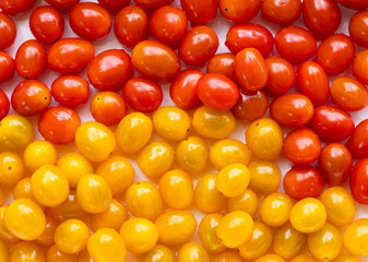High angle view of full frame image of bright red and yellow tomatoes.