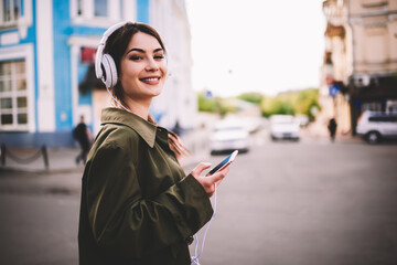 Fototapeta premium Happy woman with gadgets on city street