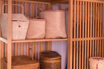 Fototapeta na wymiar Women's Boxes, baskets, containers made of wooden natural materials, Set in a stylish wardrobe, Fashionable and elegant interior furnishings