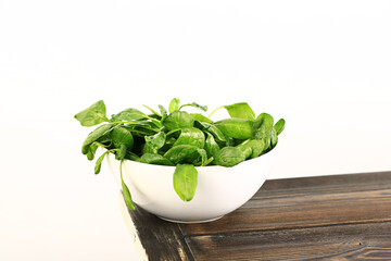 spinach in a plate on a table. Healthy wholesome food. Vegetarian food. Selective soft focus