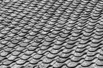 Monochrome photo. Geometric pattern. Old shingles on the roof of the house