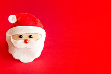 Christmas decoration. Santa Claus doll on red background.