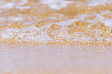 oncoming wave on the fine sea sand on the shore