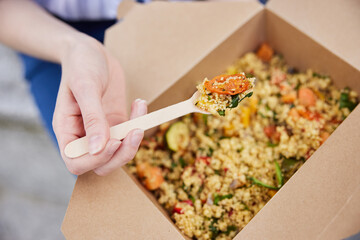 Close Up Of Woman Eating Healthy Vegan Or Vegetarian Takeaway Lunch From Recyclable Packaging With...