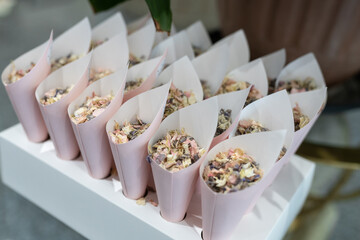 Wedding confetti in cone paper holders natural flower petals ready to throw over bride and groom...