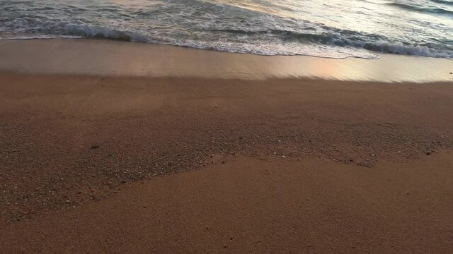 Beautiful sunset beach n golden yellow sand with shiny sea water reflection of bright sunlight ray n ocean white foam wave at Andaman coast in tropical summer sunlight, 4k cinemagraphs b-roll footage