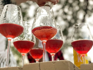 Red or rose wine being poured into glasses