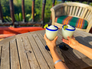Woman grabbing margaritas on a sunny day in mexico 