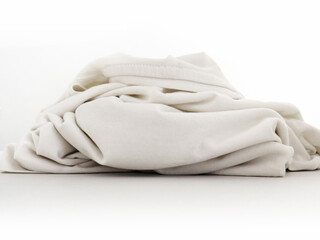 Front view of piece of wrinkled white cloth on white background. Close up of part of white t-shirt isolated. Folded white cotton rag texture.