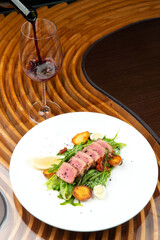 fried tuna on a pad of green beans