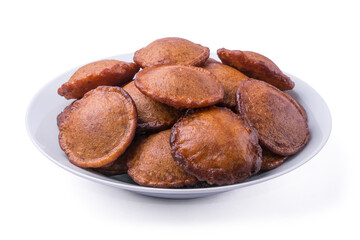 plate of deep fried sri lankan sweet called kevum or kavum, traditional dessert made from rice flour and palm sugar or kithul sugar isolated on white background
