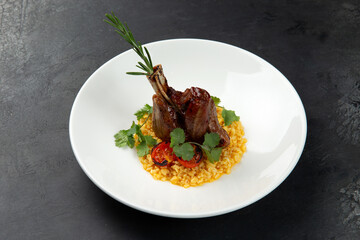 Lamb shank on a pillow of risotto, in a plate