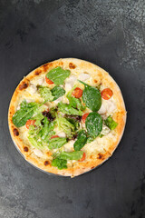 pizza with chicken, herbs, tomatoes and cheese.