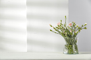 Fresh flowers on desk and wall background 