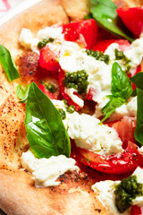 Fresh pizza made from yeast dough from wood-fired oven with mozzarella and basil