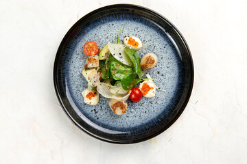 Fried scallops with herbs and red caviar.