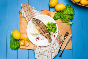 Grilled seabass with lemon and fresh vegetables. Rustic Served Dish