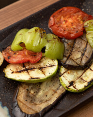 Grilled vegetables. Freshly cooked bell pepper, zucchini, tomato and eggplant on baking sheet. Close up shot. Soft focus. Healthy food.