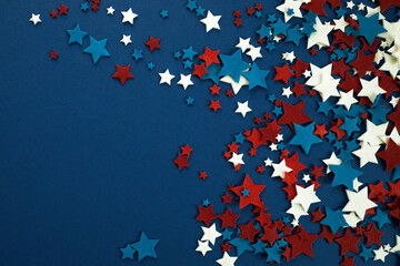 4th of July American Independence Day stars decorations on blue background. Flat lay, top view.