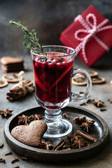 Glass with mulled wine and spices, selective focus