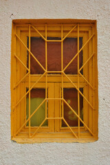 Grilled window in the plastered wall