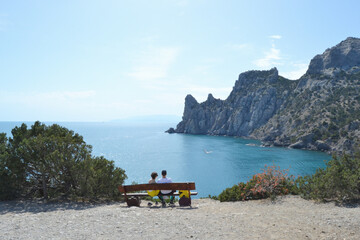 Seascape, Crimean peninsula. A wooden bench stands on the shore of the Blue Bay. National botanical reserve New World.