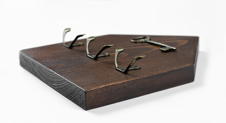 Wooden house. Wooden key holder. Place for hanging the key. On white background.