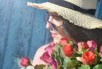 Happy woman with roses in sunglasses