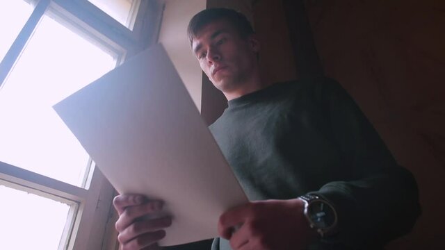 A man holds documents in his hands, examines them. Analysis of information, the formation of business analytics. Focus on workflow.