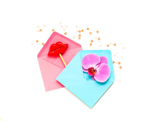 Pink and blue envelopes with decorative lips on stick. Festive concept or Romantic Love message. Creative copy space