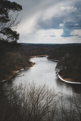 landscape photo of a river with stormy clouds above