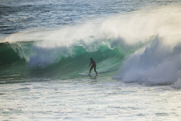 Surfer on Blue Ocean Wave . Surf spot in Ericeira Portugal.