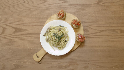 Serving a plate of spaghetti, spinach and mushroom