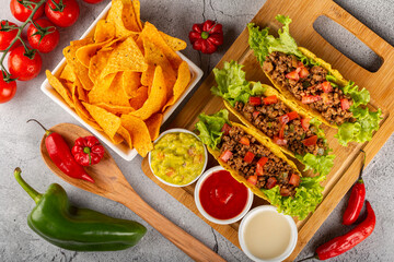Mexican tacos with lettuce, beef and tomatoes.