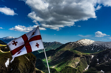 Georgian flag flying in Caucasus mountains, Gudauri, Georgia