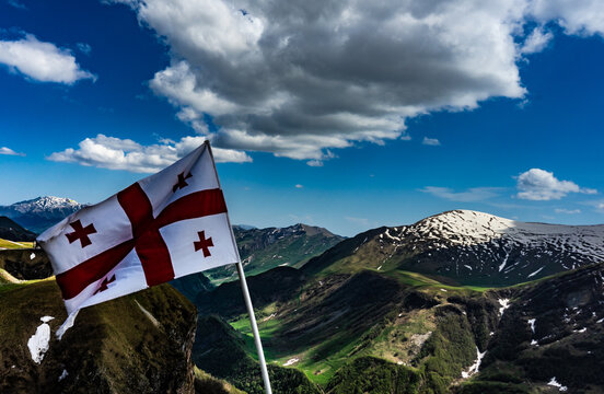 Georgian flag flying in Caucasus mountains, Gudauri, Georgia
