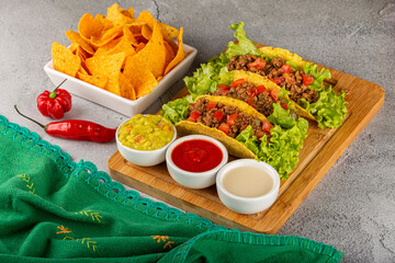 Mexican tacos with lettuce, beef and tomatoes.