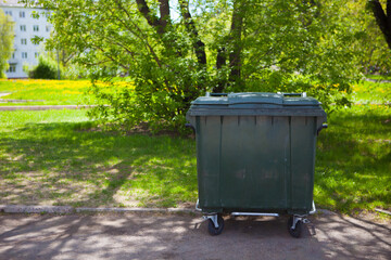 Recycle bins in the public park near the street front of tree background